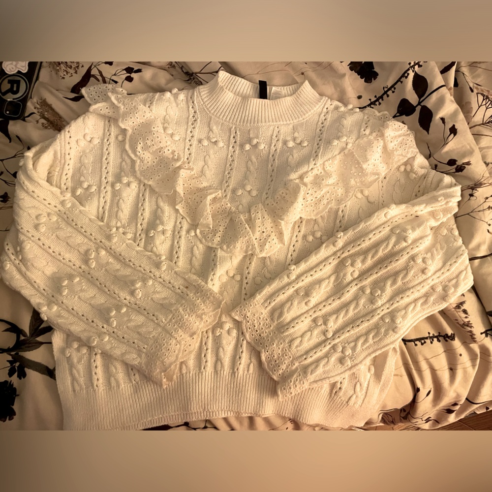 White sweater with ruffle embellishment